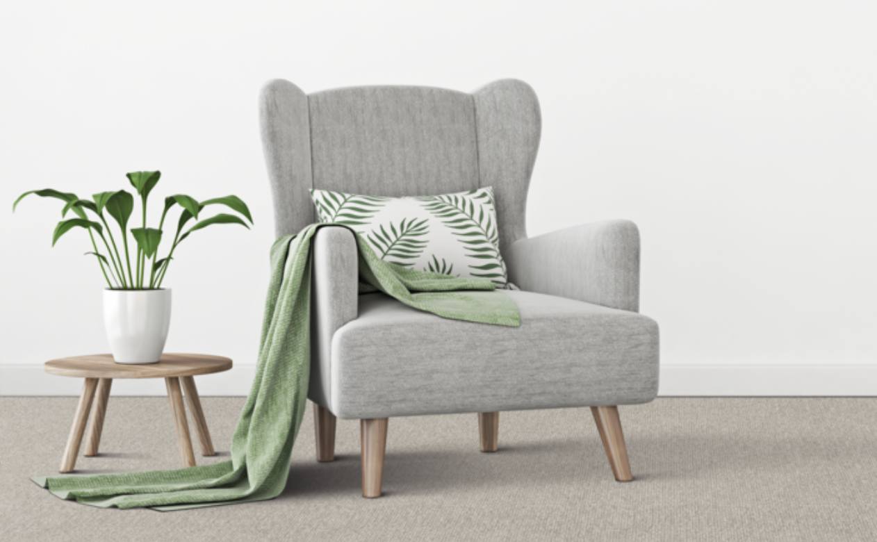 grey chair on grey carpet with wood side table and Lime Cream decor.