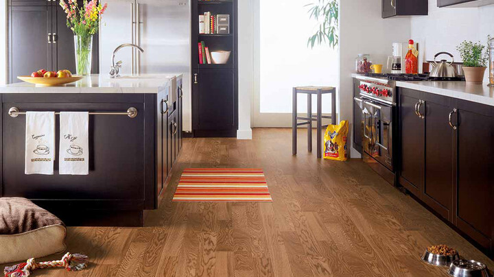 luxury vinyl wood look flooring in kitchen with white stone look countertops 