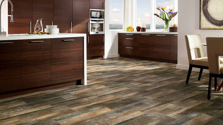 luxury vinyl wood look flooring in kitchen with white stone waterfall countertop