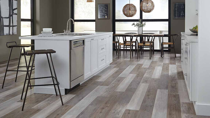 vinyl plank wood look flooring with white stone countertops in kitchen